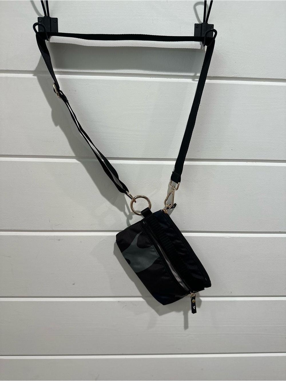 Sleek Black Crossbody Pouch with Gold Ring Detail
